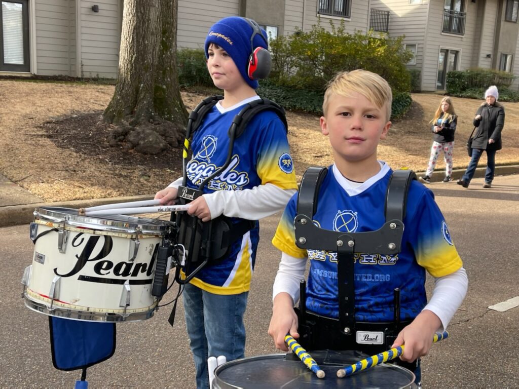Two boys holding drums and sticks